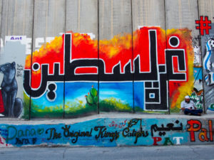 Graffiti of the words Palestine and Gaza written in Arabic script at the separation wall in Bethlehem